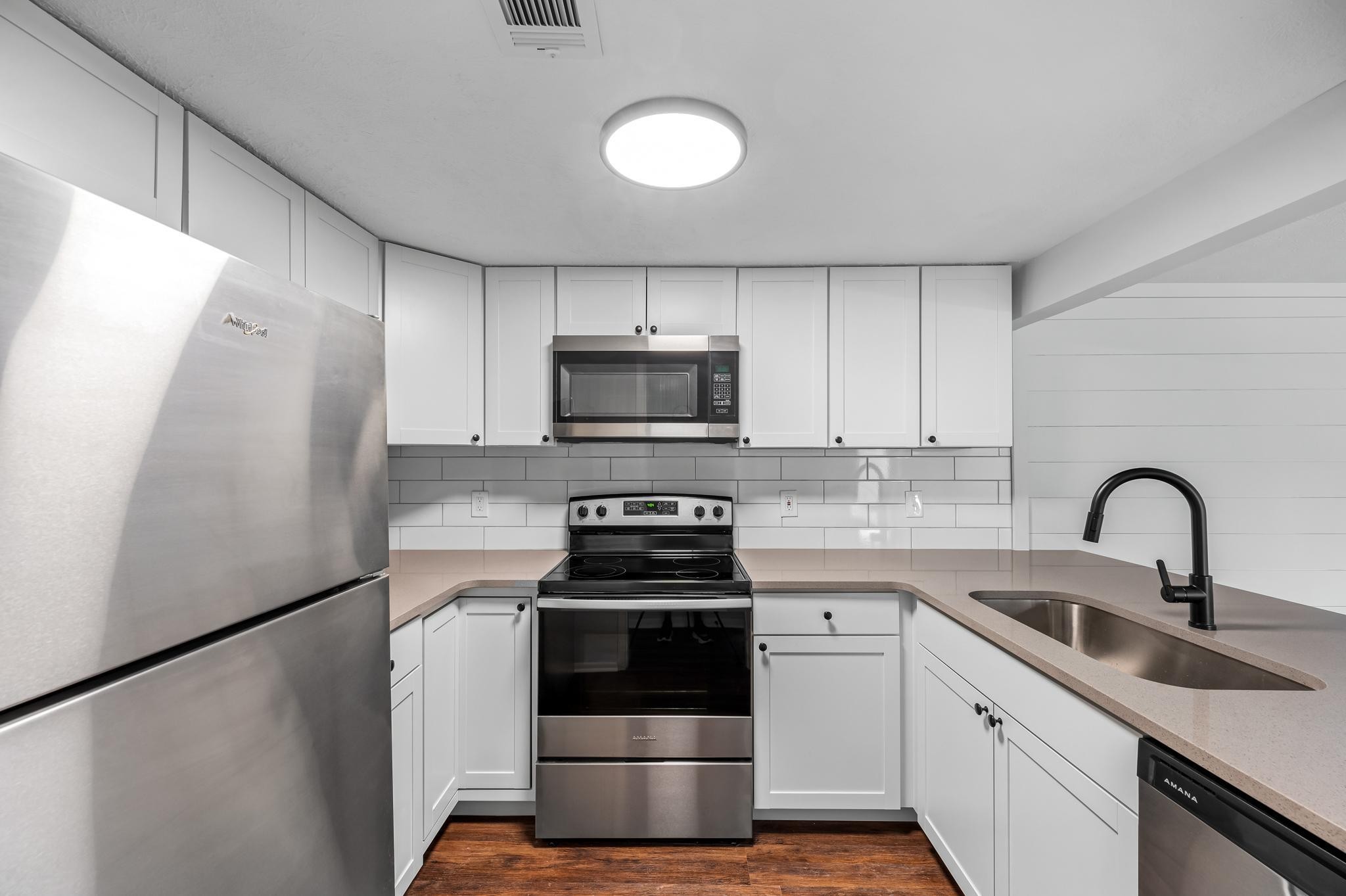 a kitchen with a sink and a stove top oven