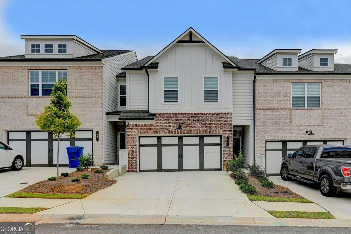 a front view of a house with cars parked