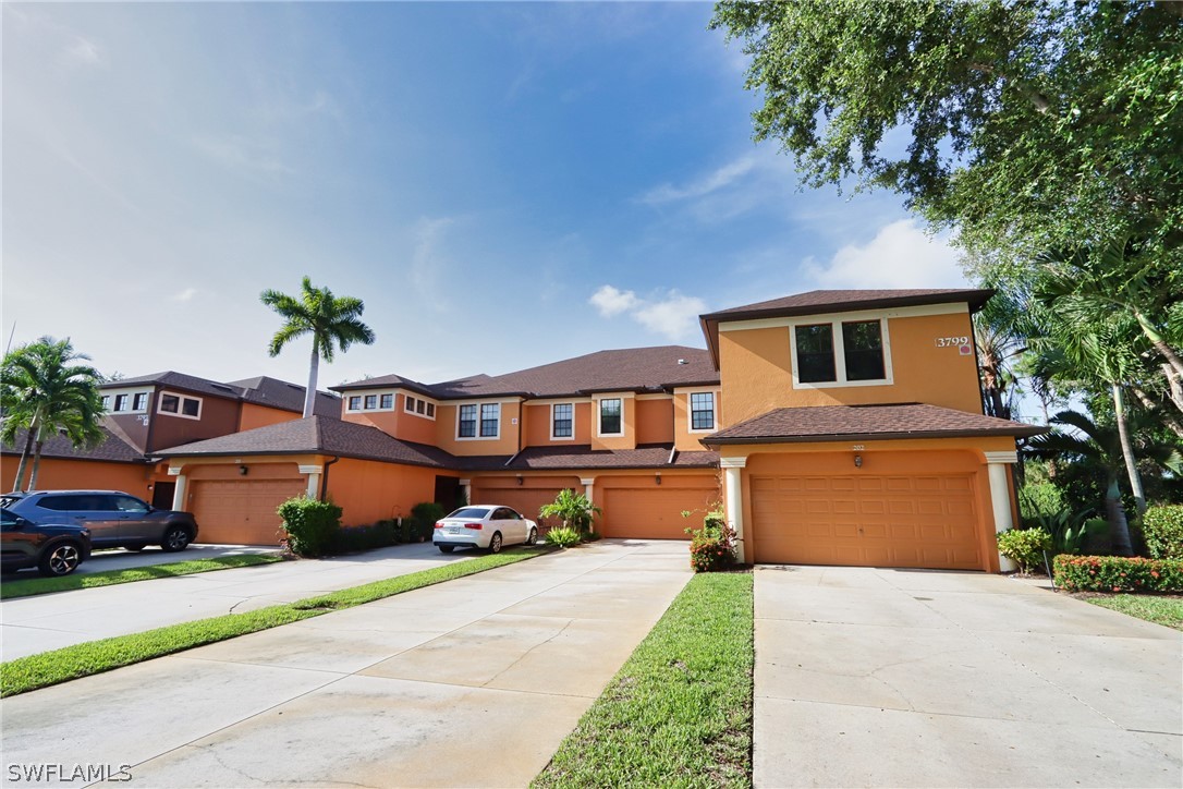 a front view of a house with a yard and a garage