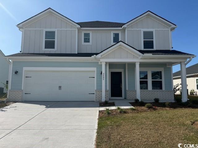 Craftsman inspired home with a garage, a front law