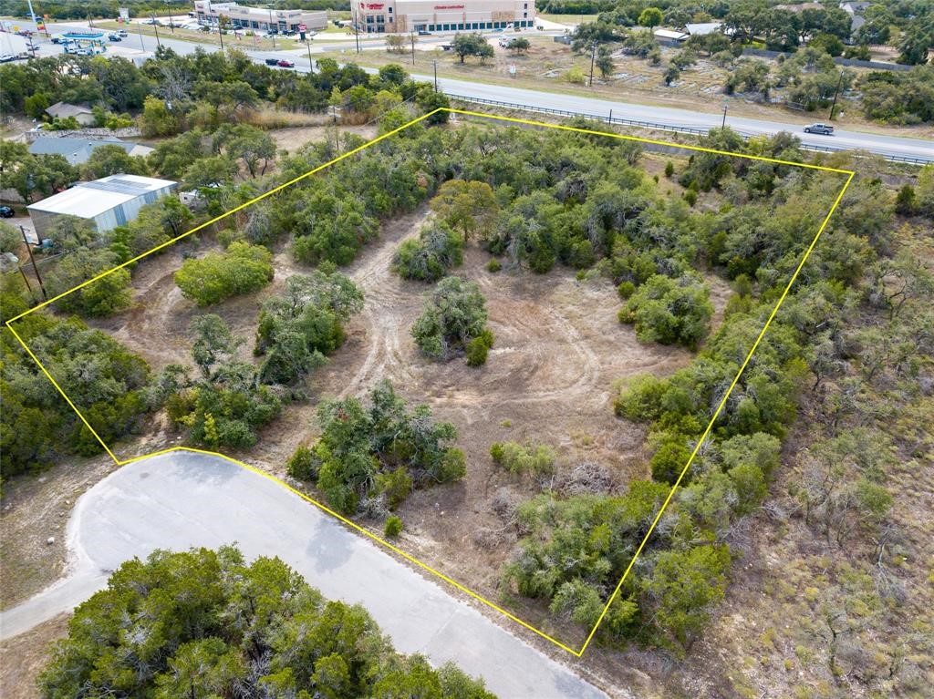 an aerial view of a house with a yard and greenery