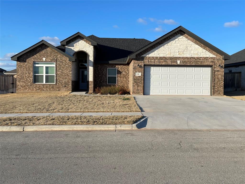 a view of a house with a yard and garage