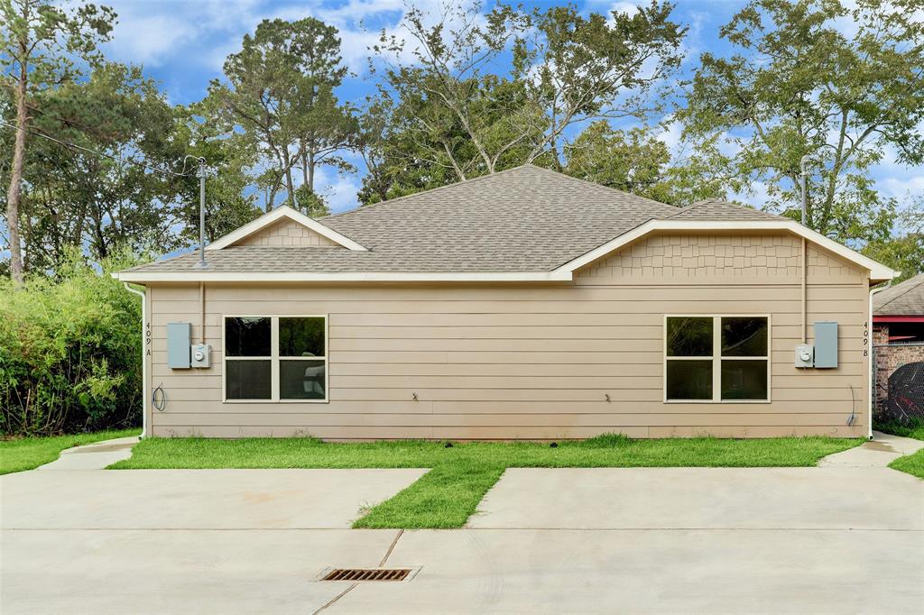 a front view of a house with a yard and a garage