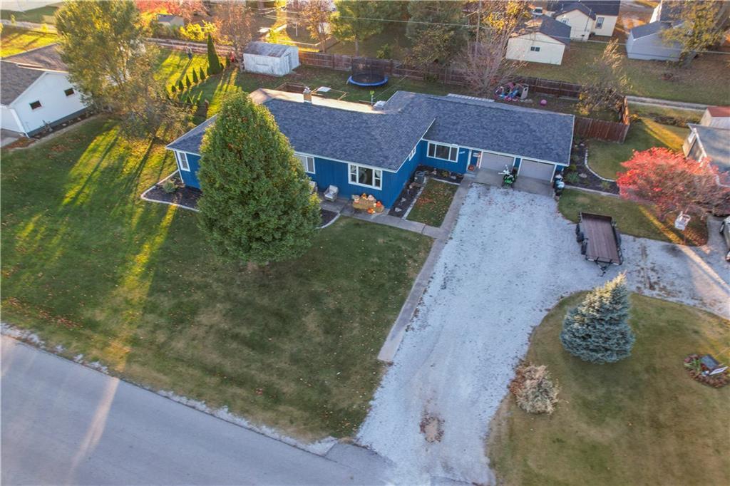 an aerial view of a house with a yard basket ball court and outdoor seating