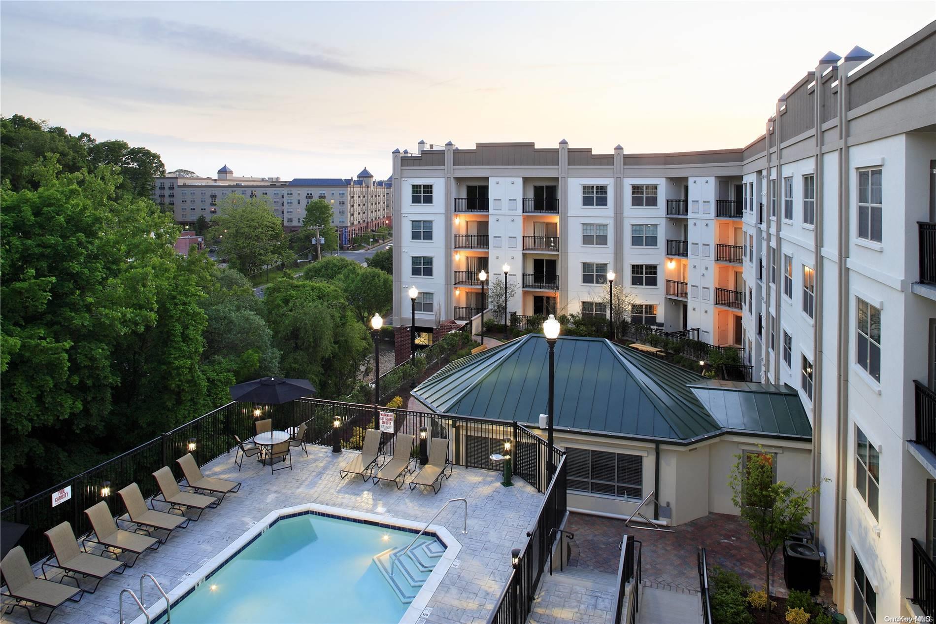 a view of a patio with swimming pool and furniture