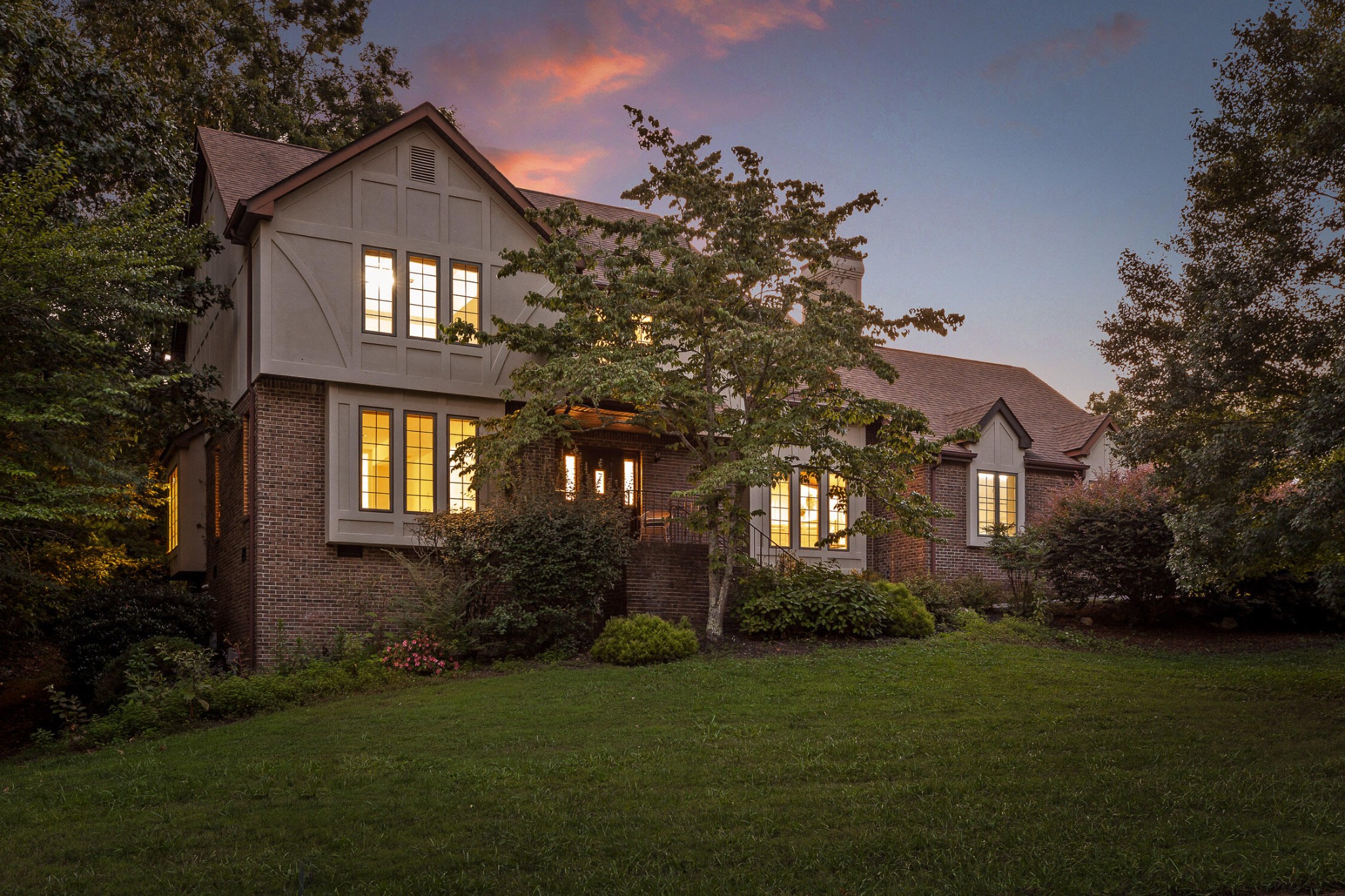 a front view of a house with a garden