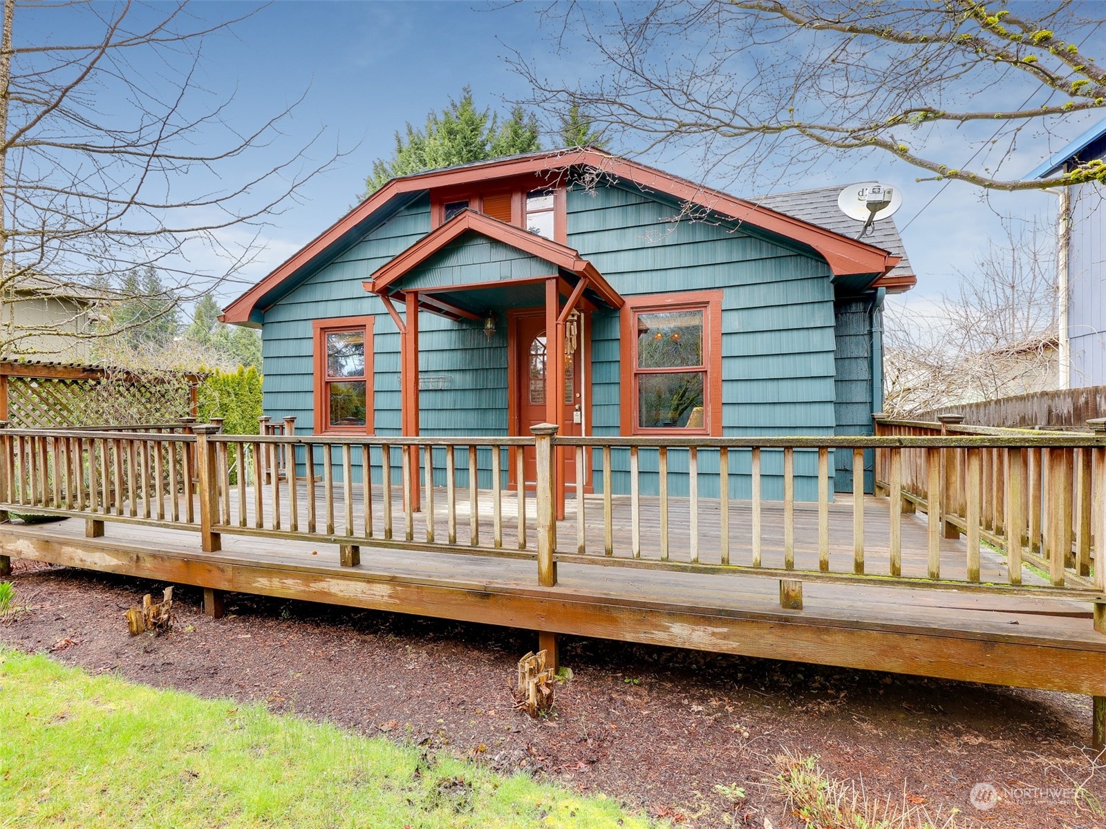 a view of a house with wooden deck and furniture