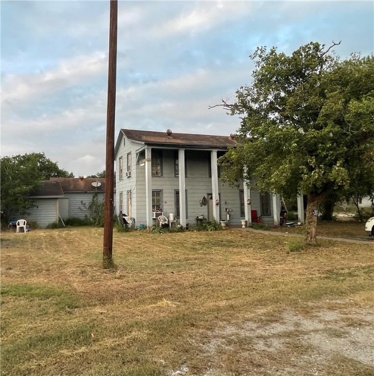 a tree is standing in front of a house