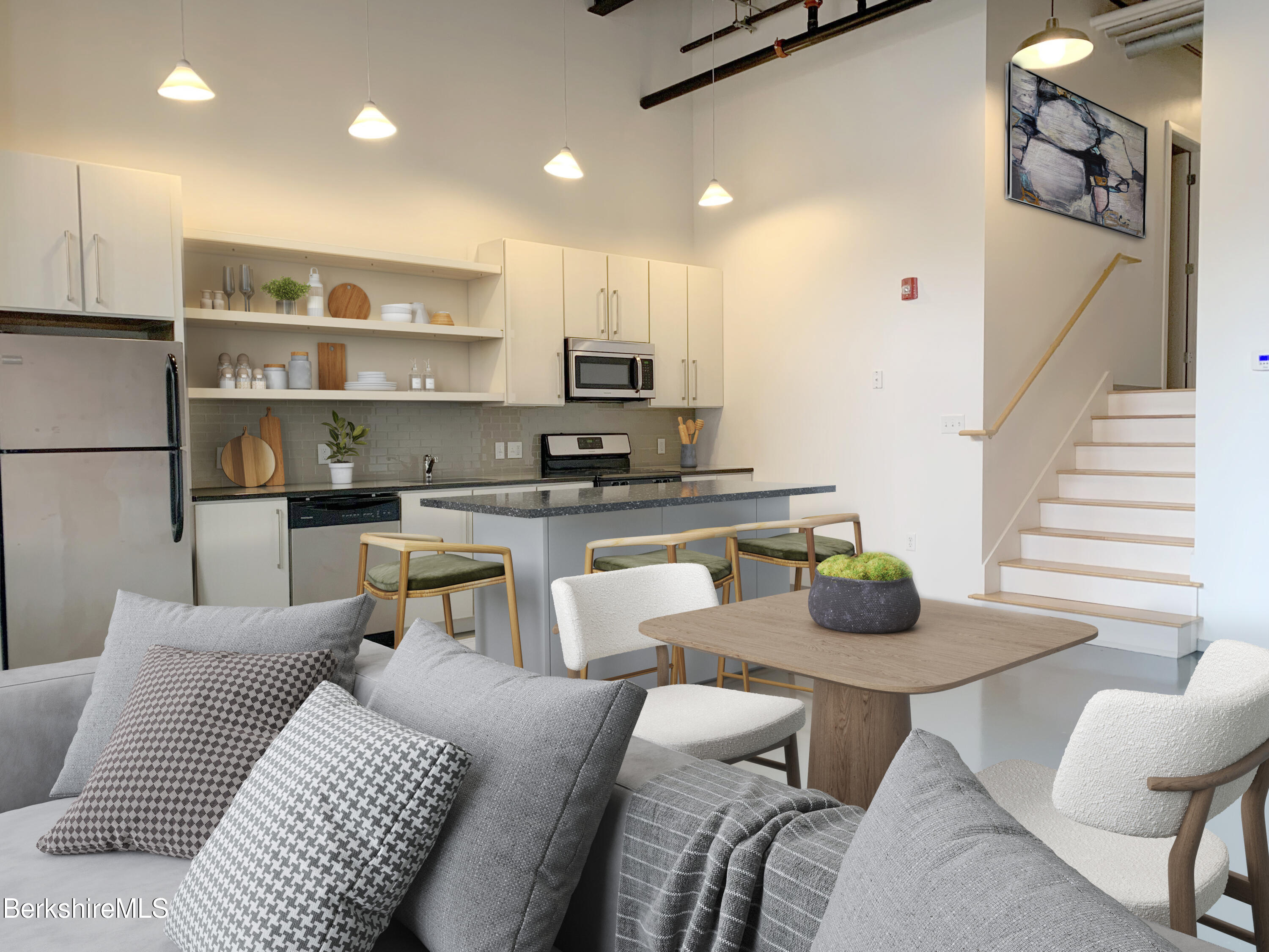 a living room with furniture and a kitchen view