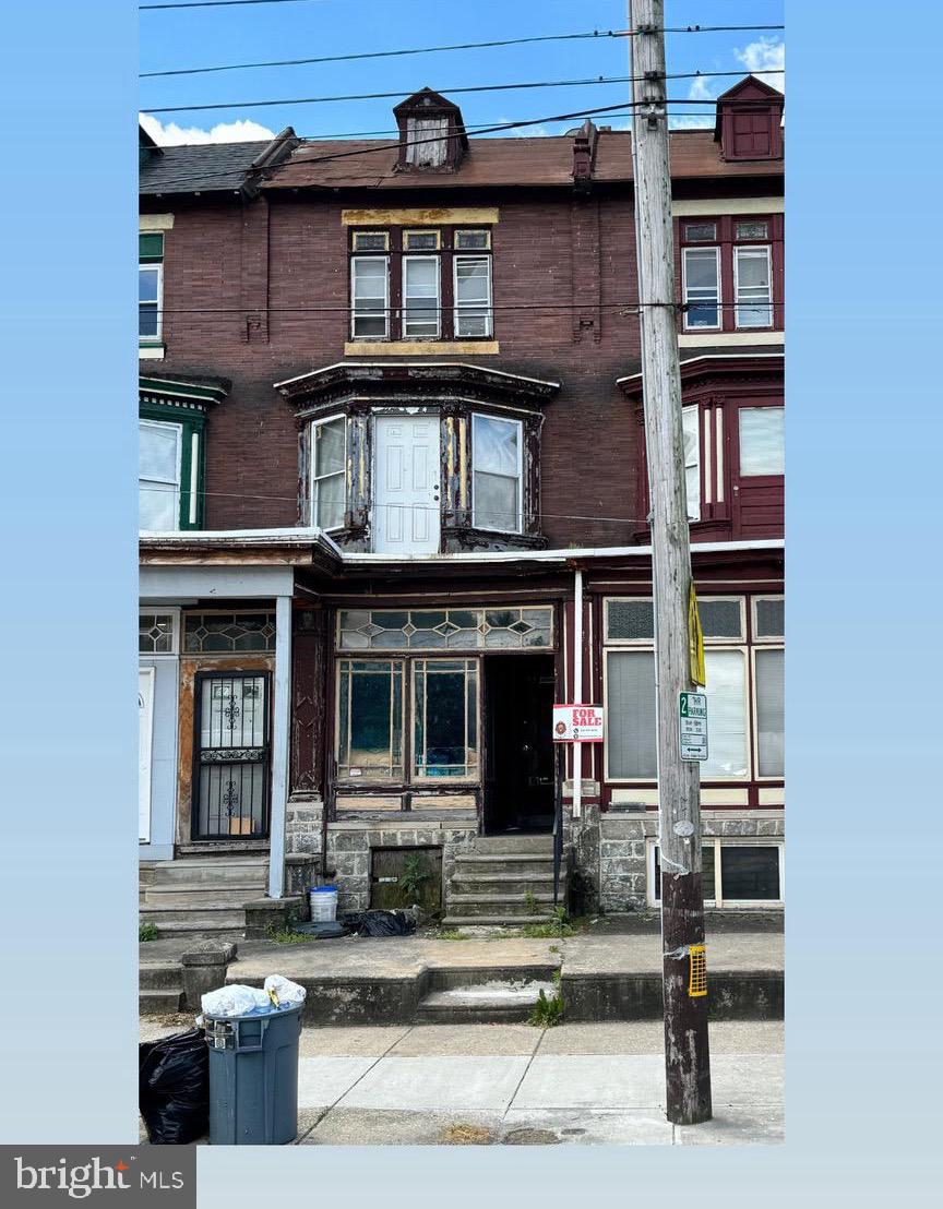 a front view of a residential apartment building with a yard