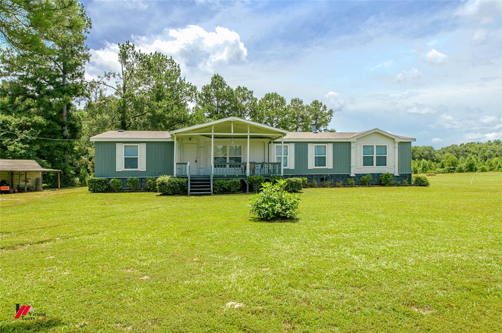 a view of a house with a backyard