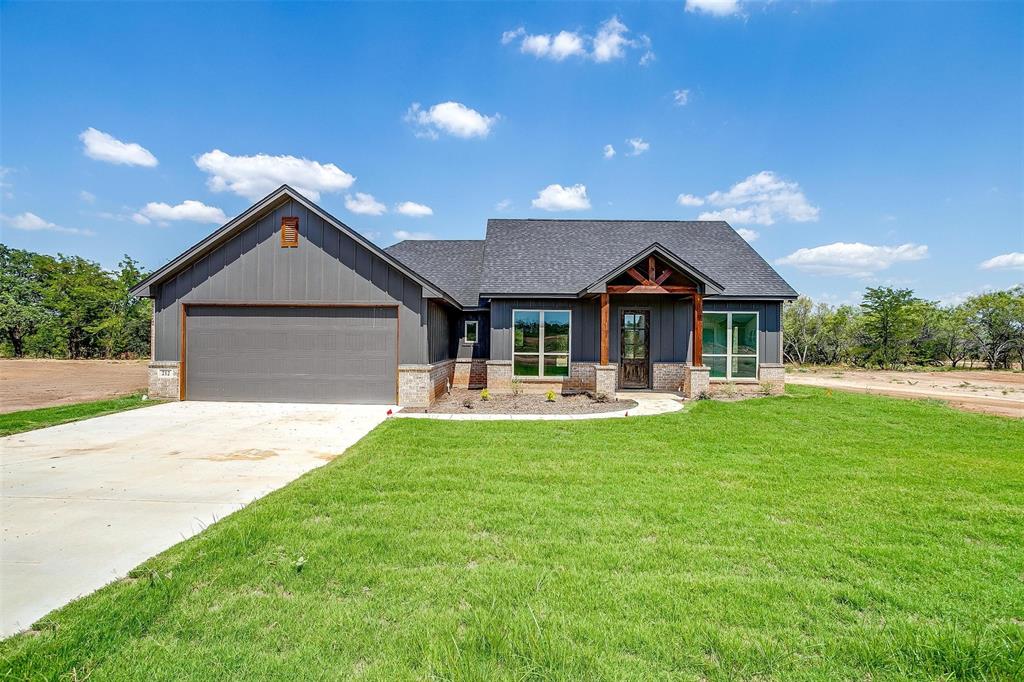 a front view of house with yard fire pit and outdoor seating