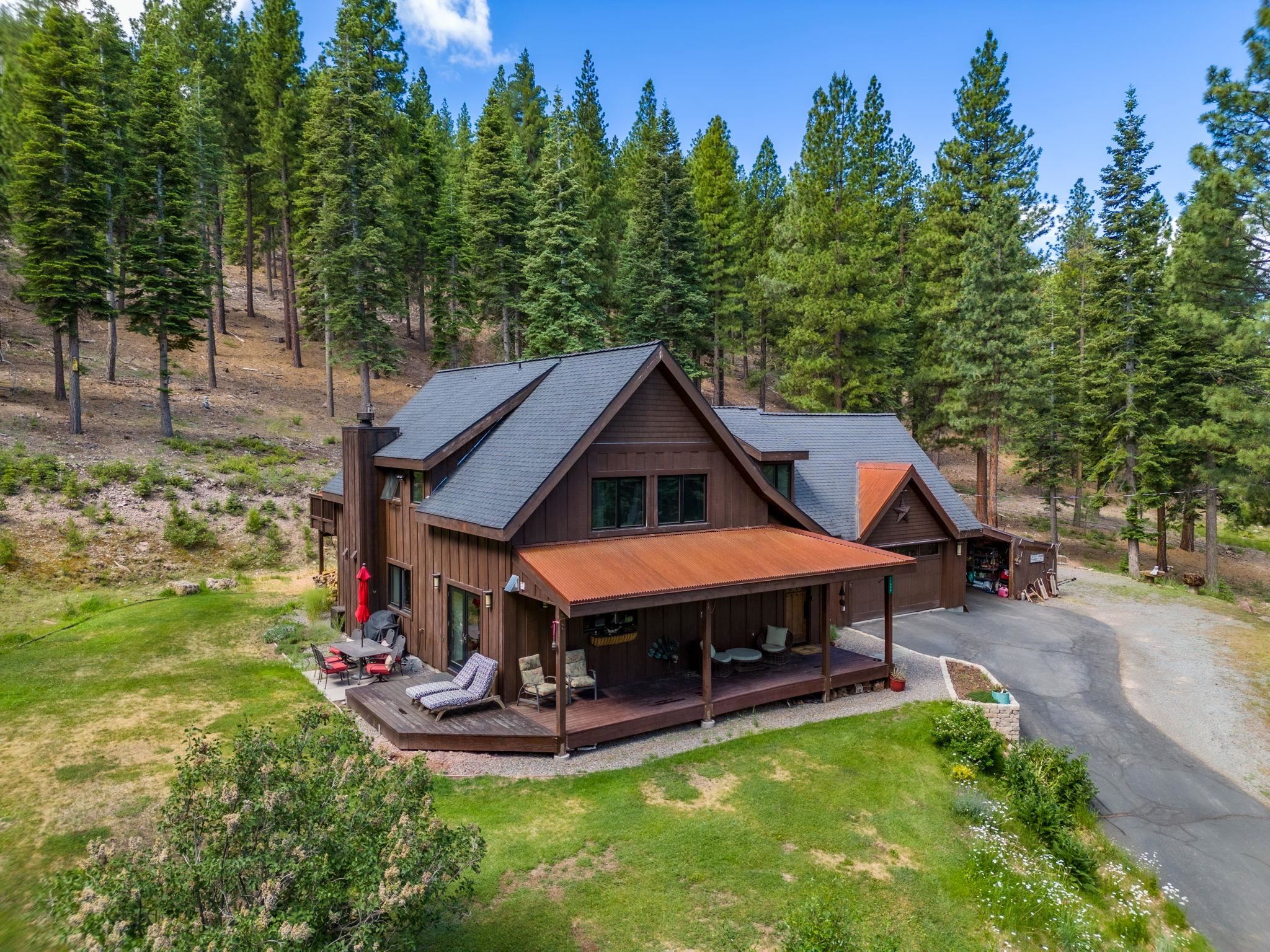 a aerial view of a house with swimming pool next to a yard