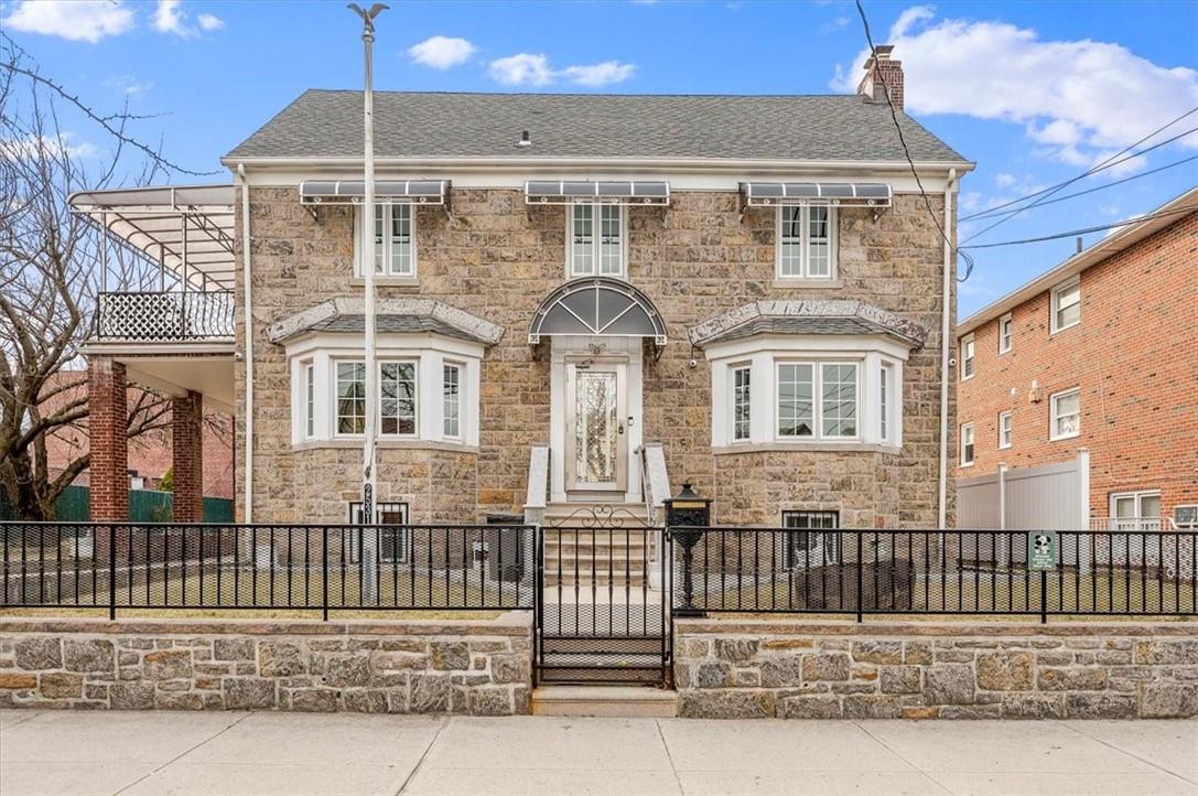 View of front of property with a balcony