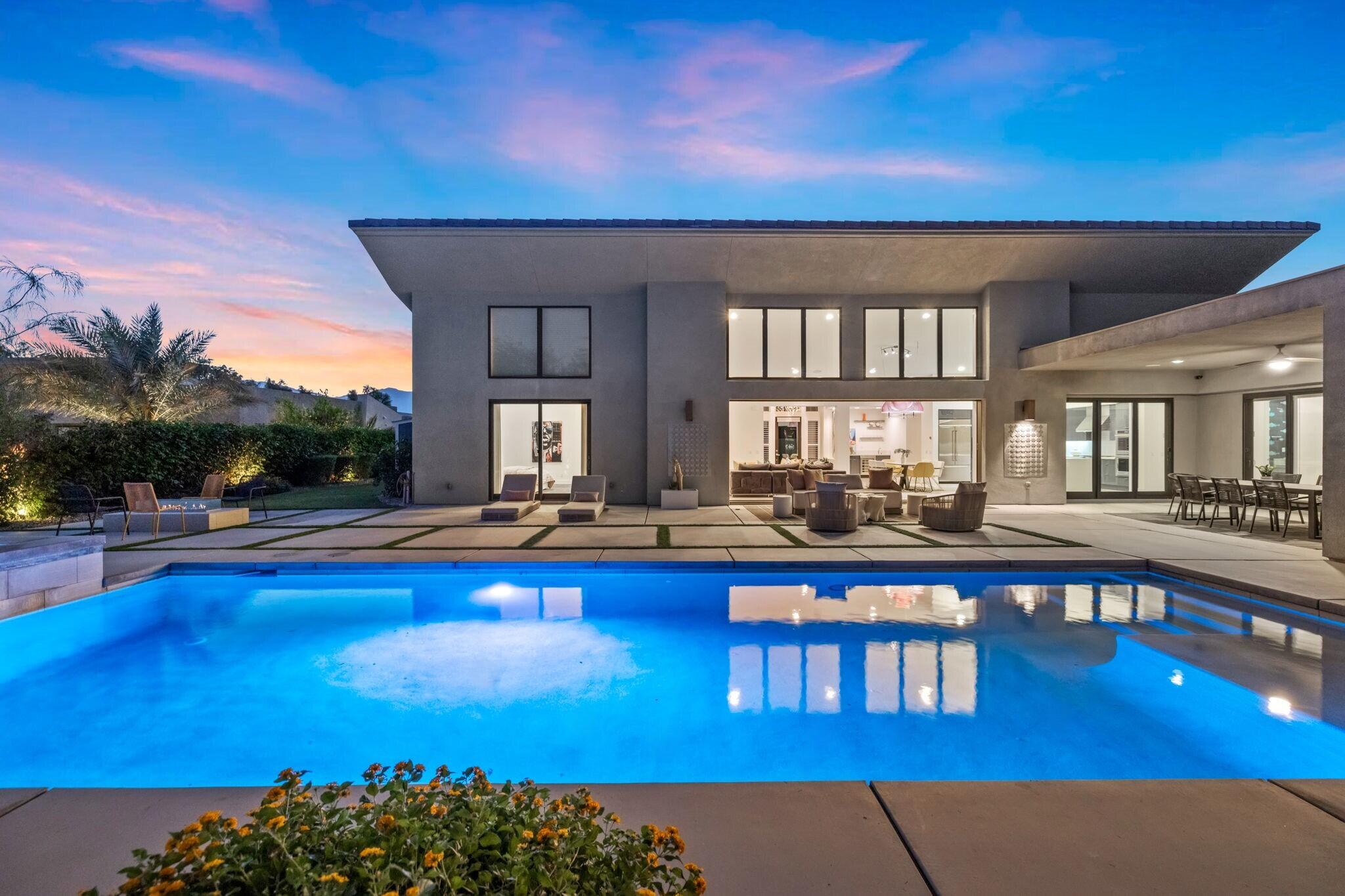 a living room with furniture a pool table and chairs