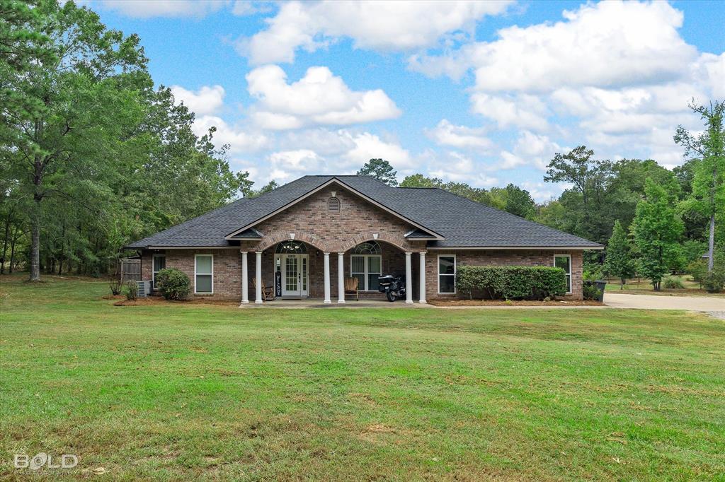 a front view of house with yard and green space