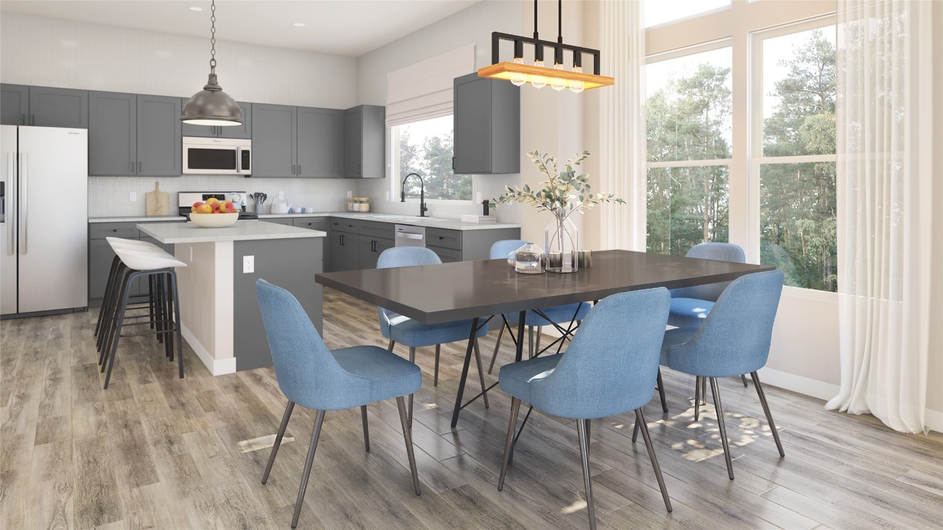 a view of kitchen with cabinets table and chairs