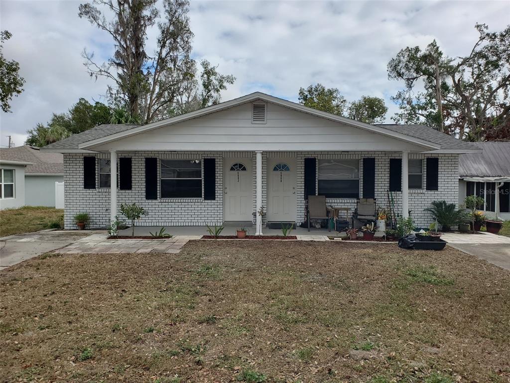 a front view of a house with yard and porch