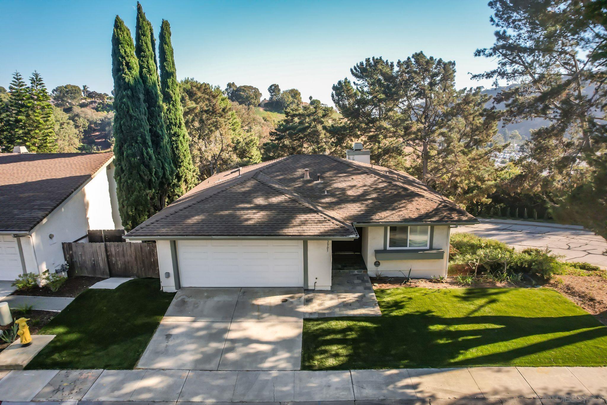 a front view of house with a garden