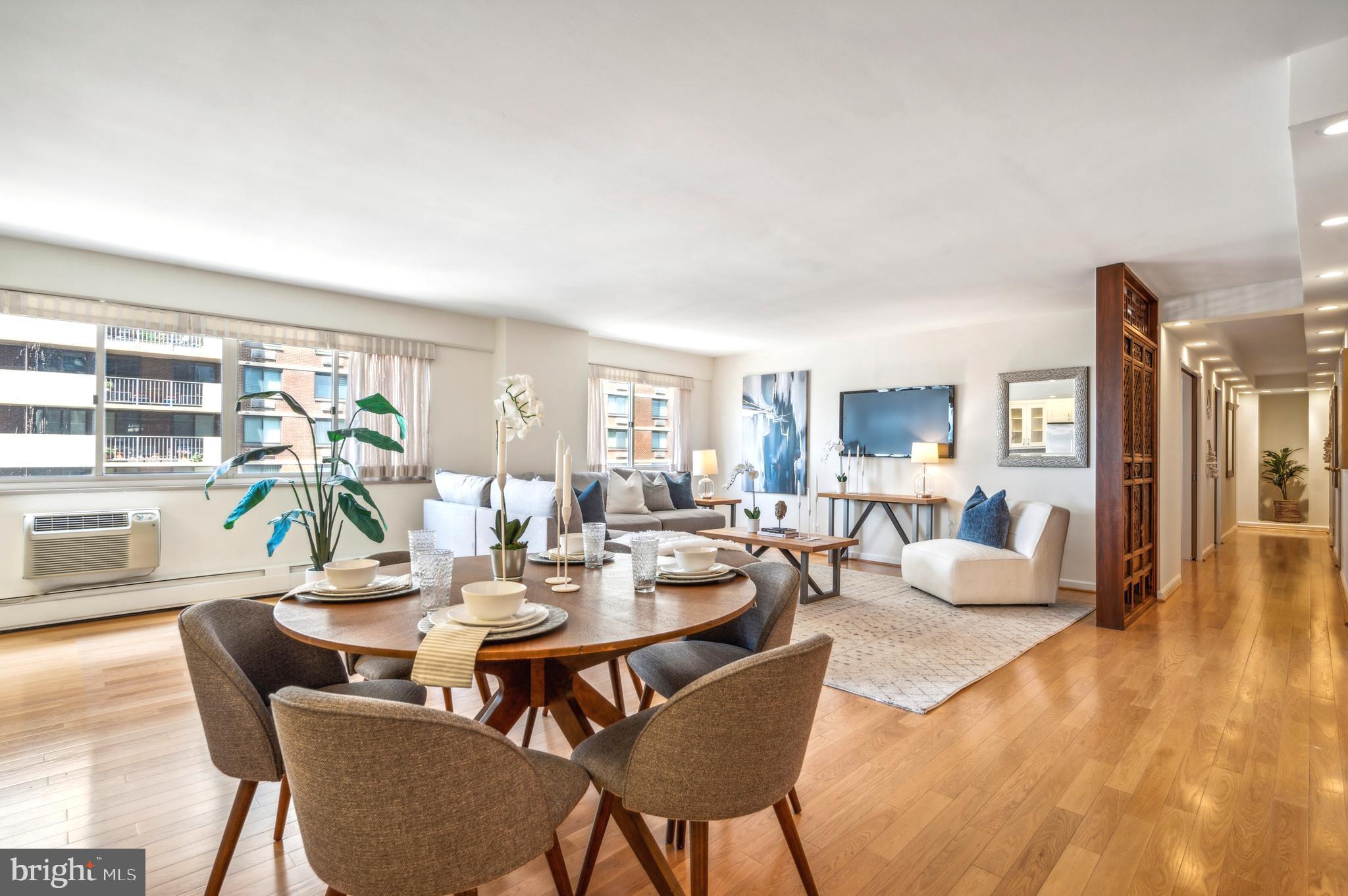 a dining room with furniture wooden floor and a rug