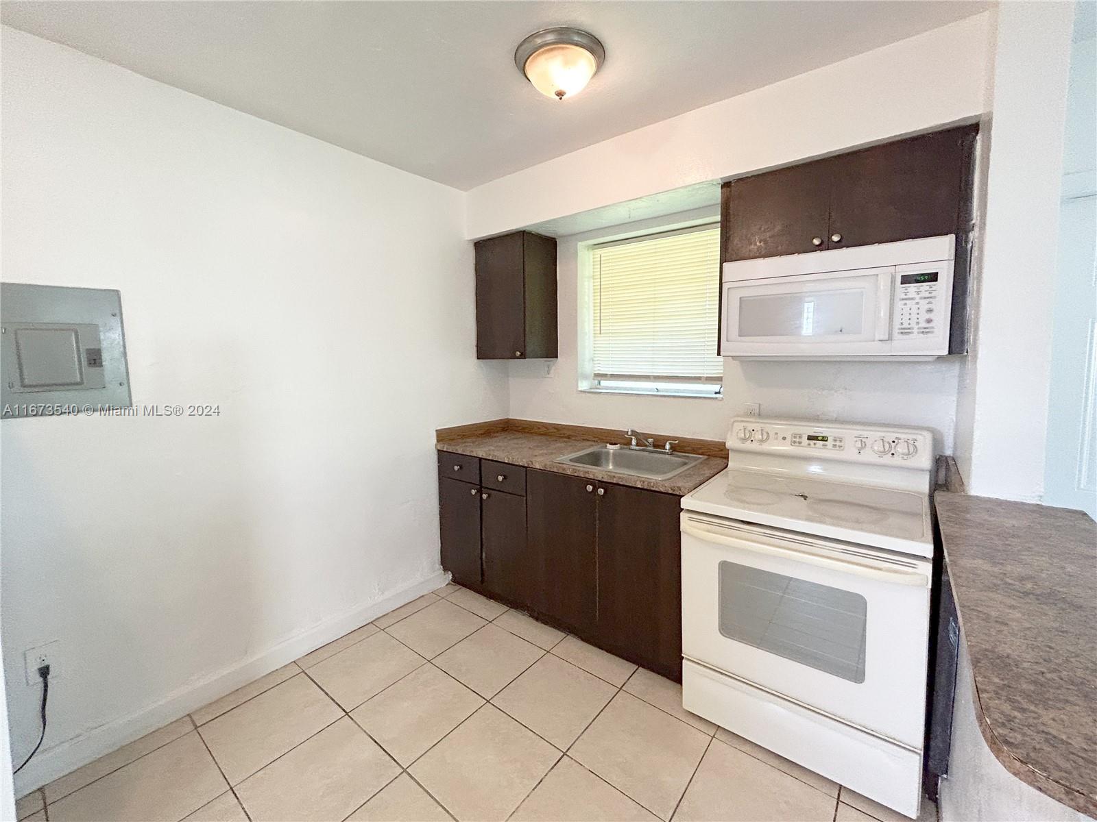 a kitchen with a stove and a microwave