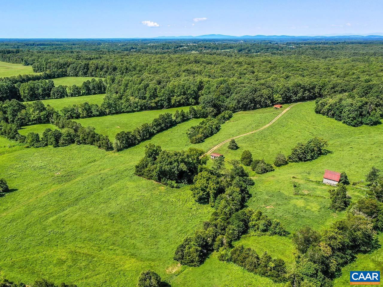 a view of a green field with an ocean