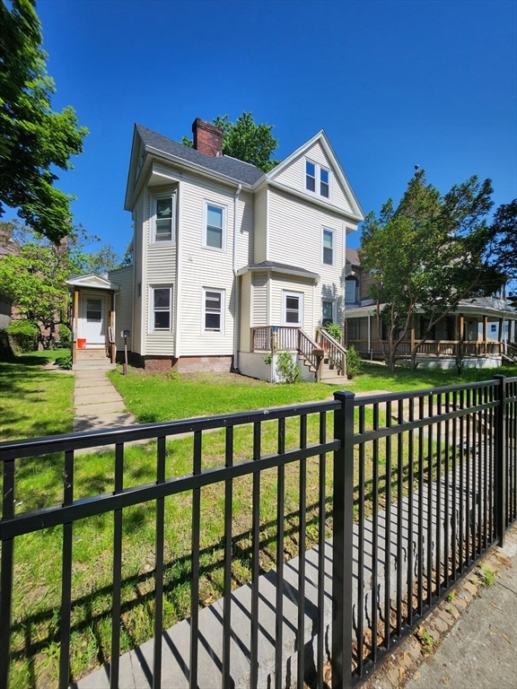 a front view of house with yard and green space