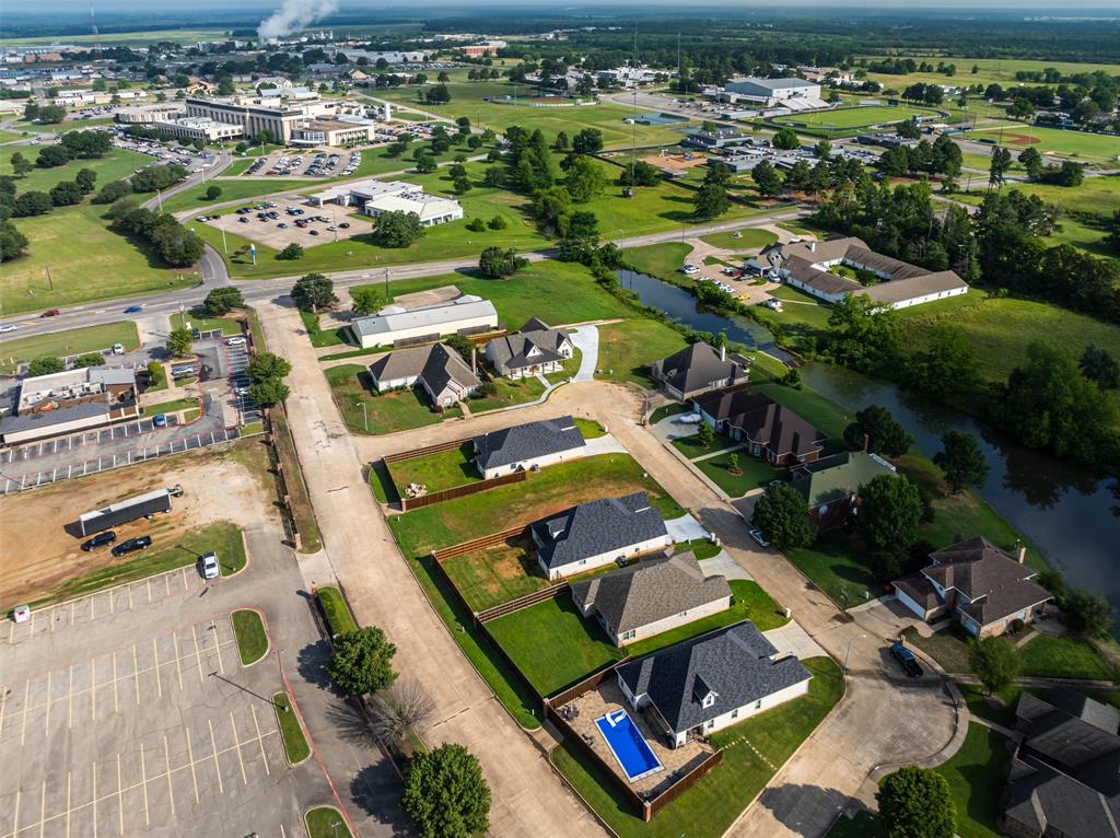 an aerial view of a pool yard and mountain view in back