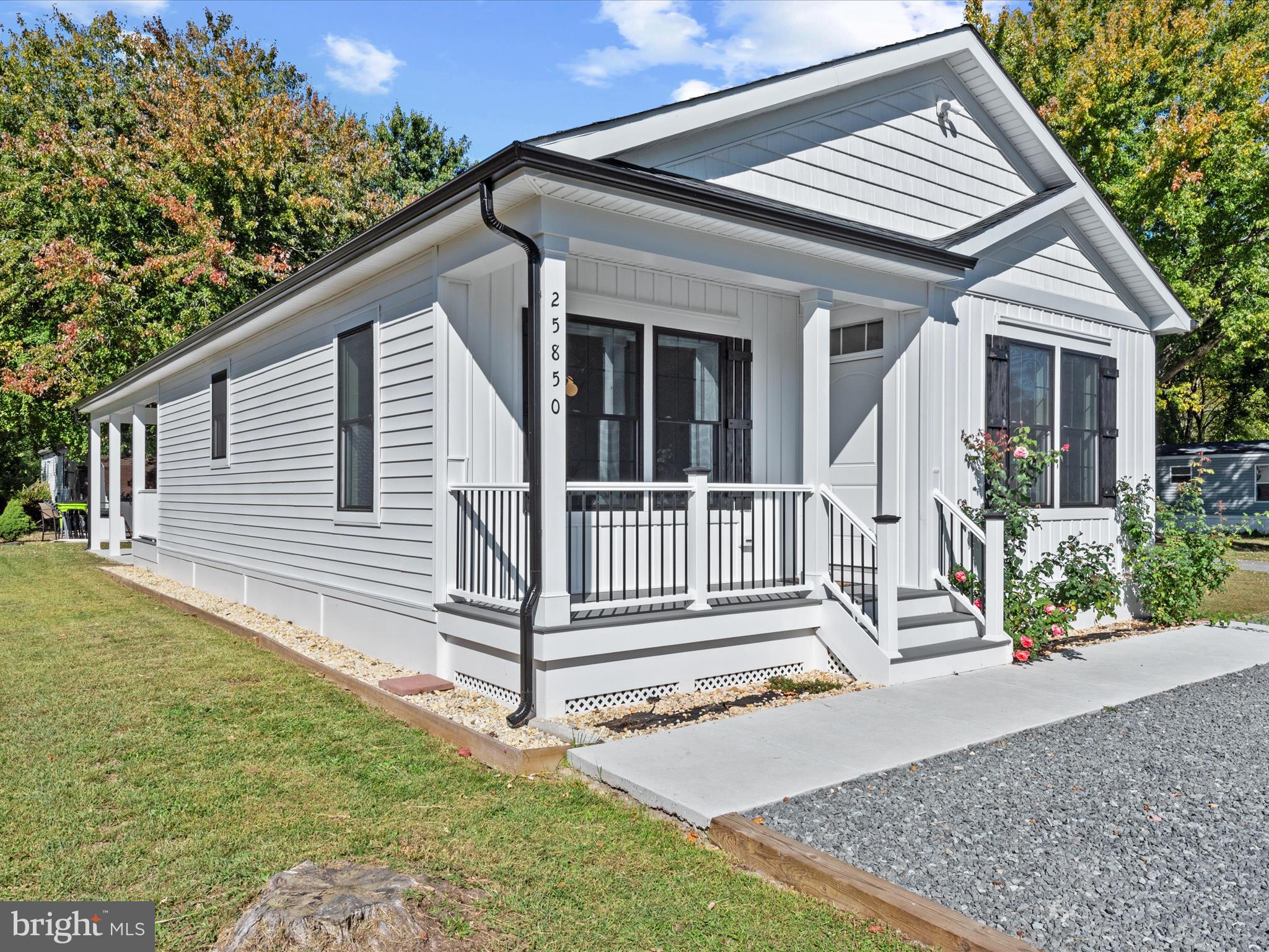 a view of a house with a yard and wooden fence