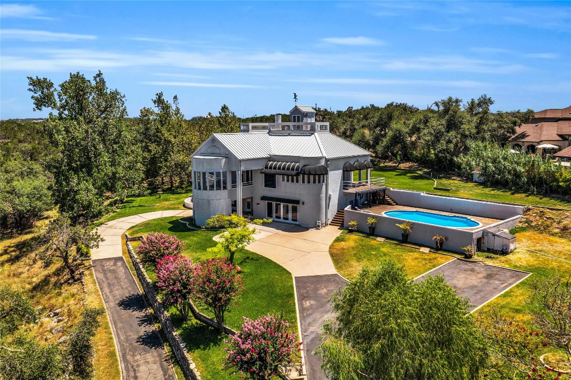 a view of a house with swimming pool and sitting area