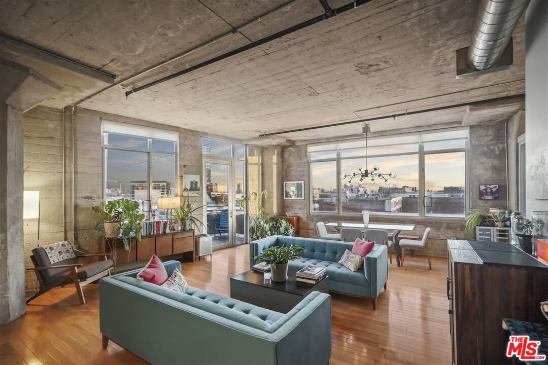 a living room with furniture and a floor to ceiling window