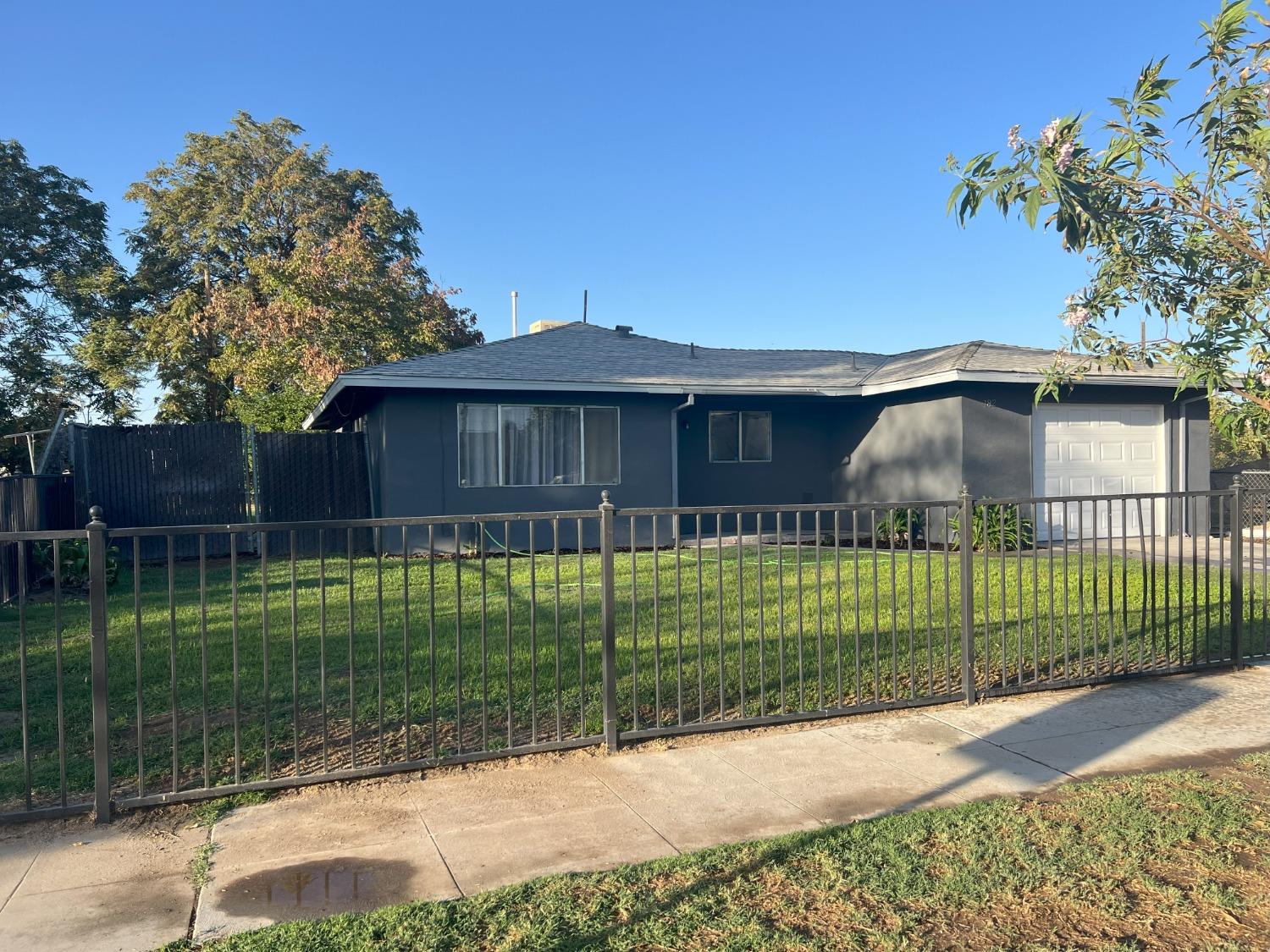 a front view of a house with a garden and plants