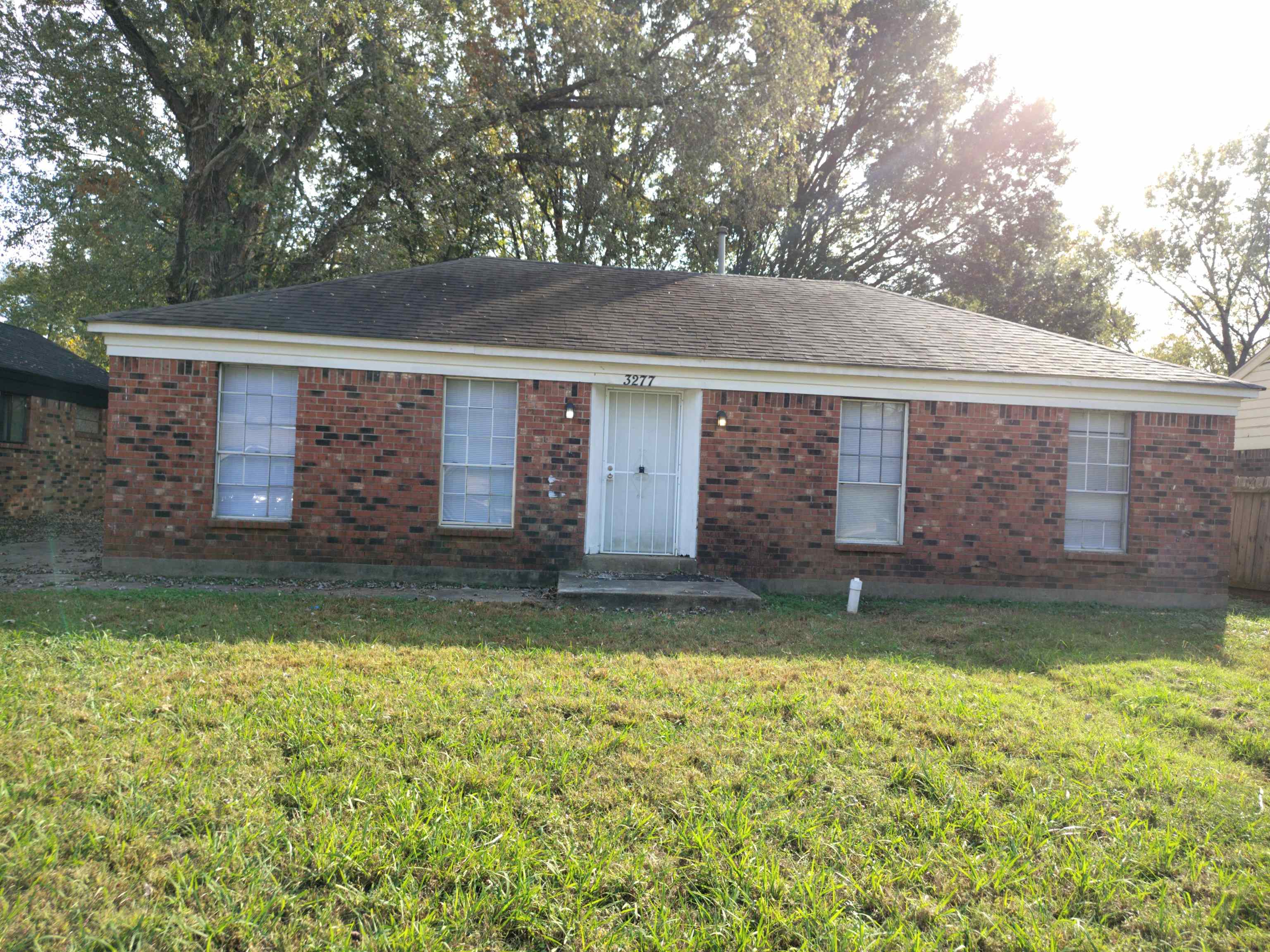 Rear view of house featuring a yard