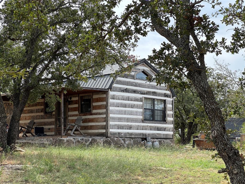 a view of house with a yard