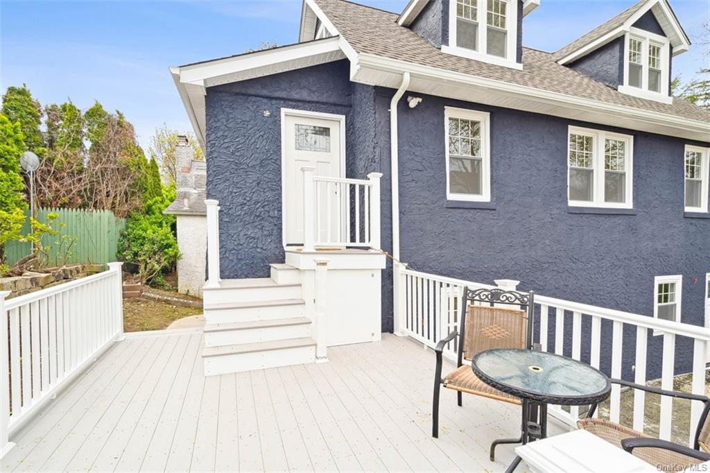 a view of a brick house with a chair and table