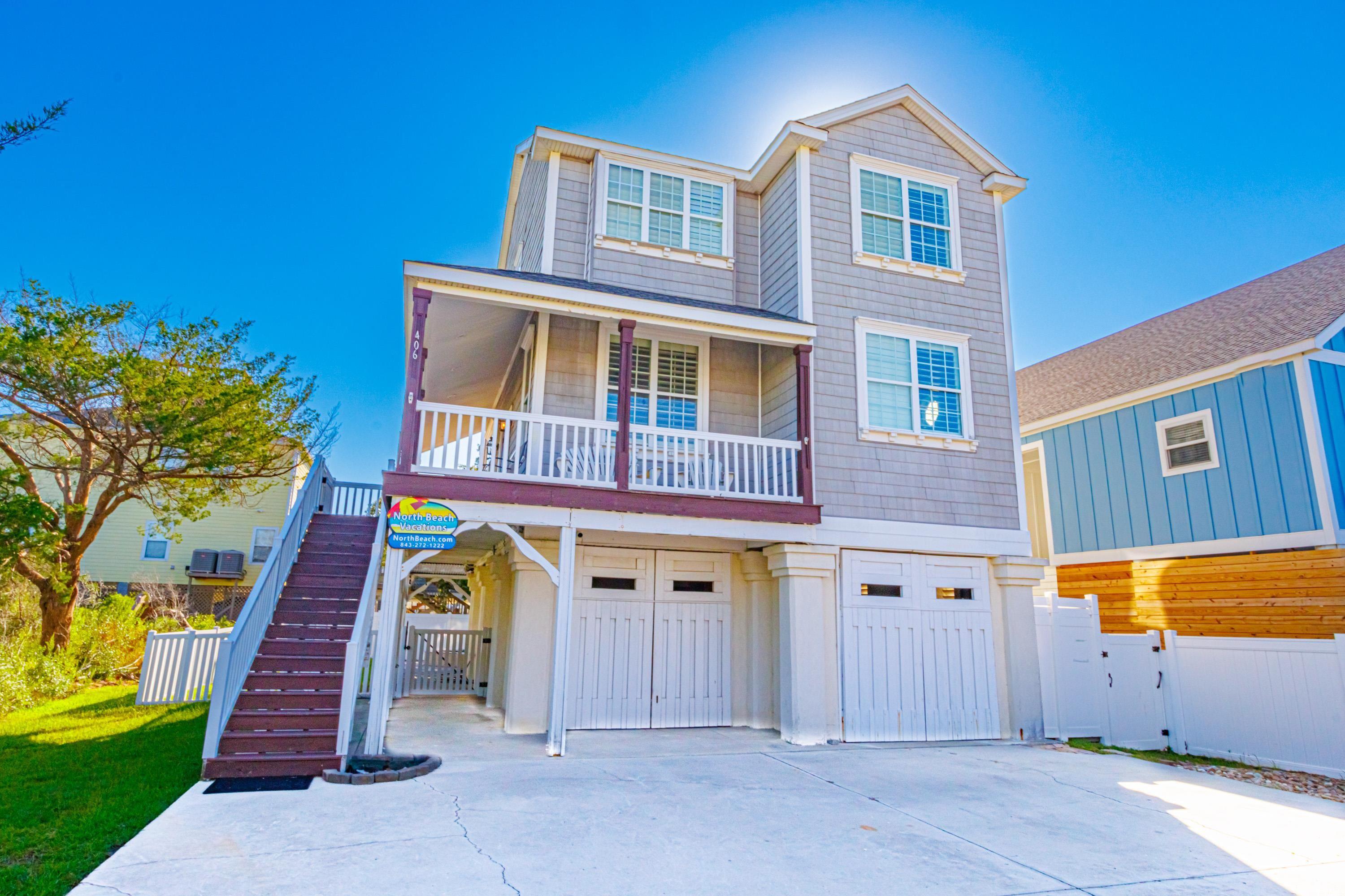 View of front of house featuring a garage and a po