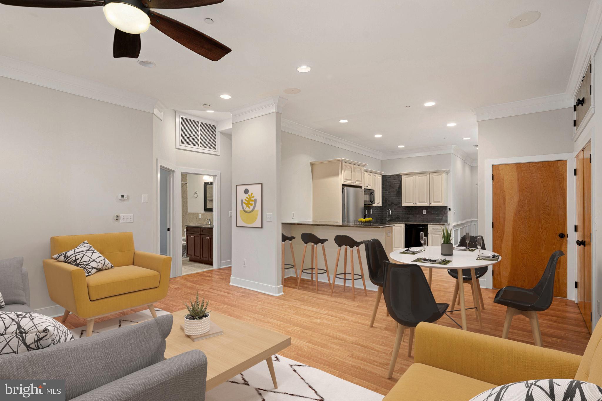 a living room with furniture kitchen view and a refrigerator