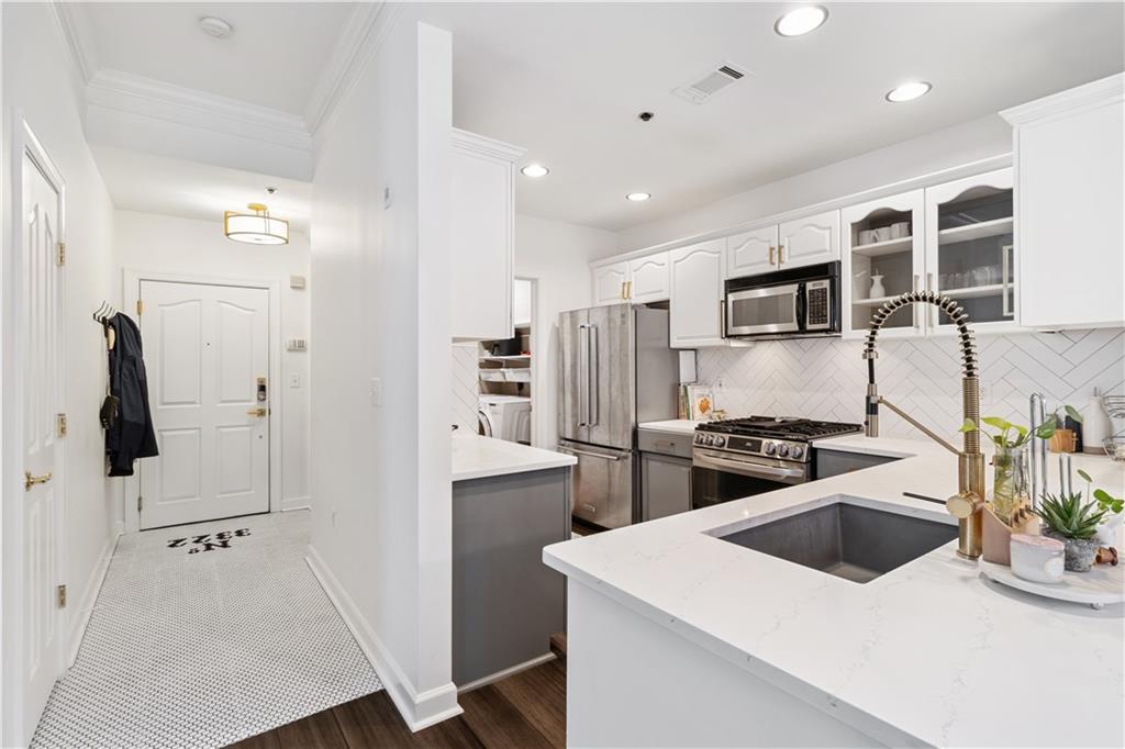 a kitchen that has a sink a stove and refrigerator