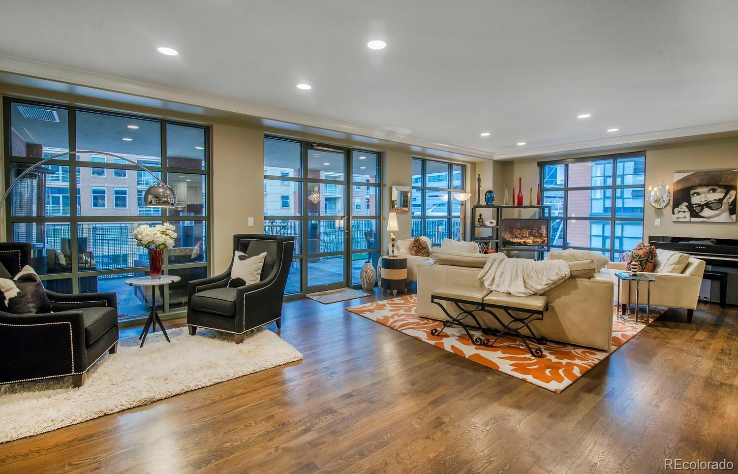 a living room with furniture hard wood floor and a book shelf