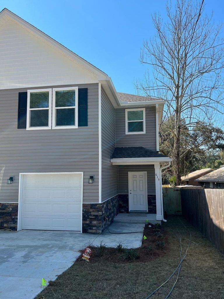 a front view of a house with garage