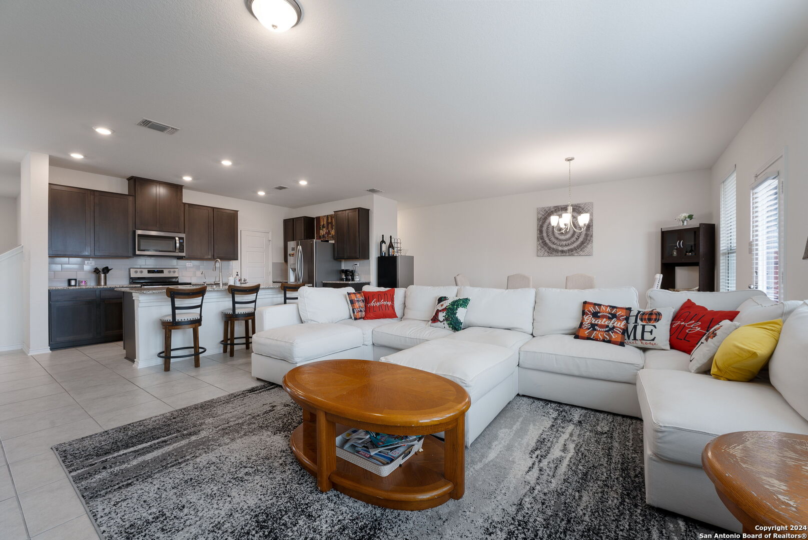 a living room with furniture and kitchen view