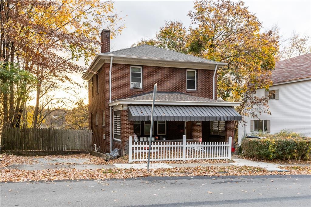 a front view of a house with a garden