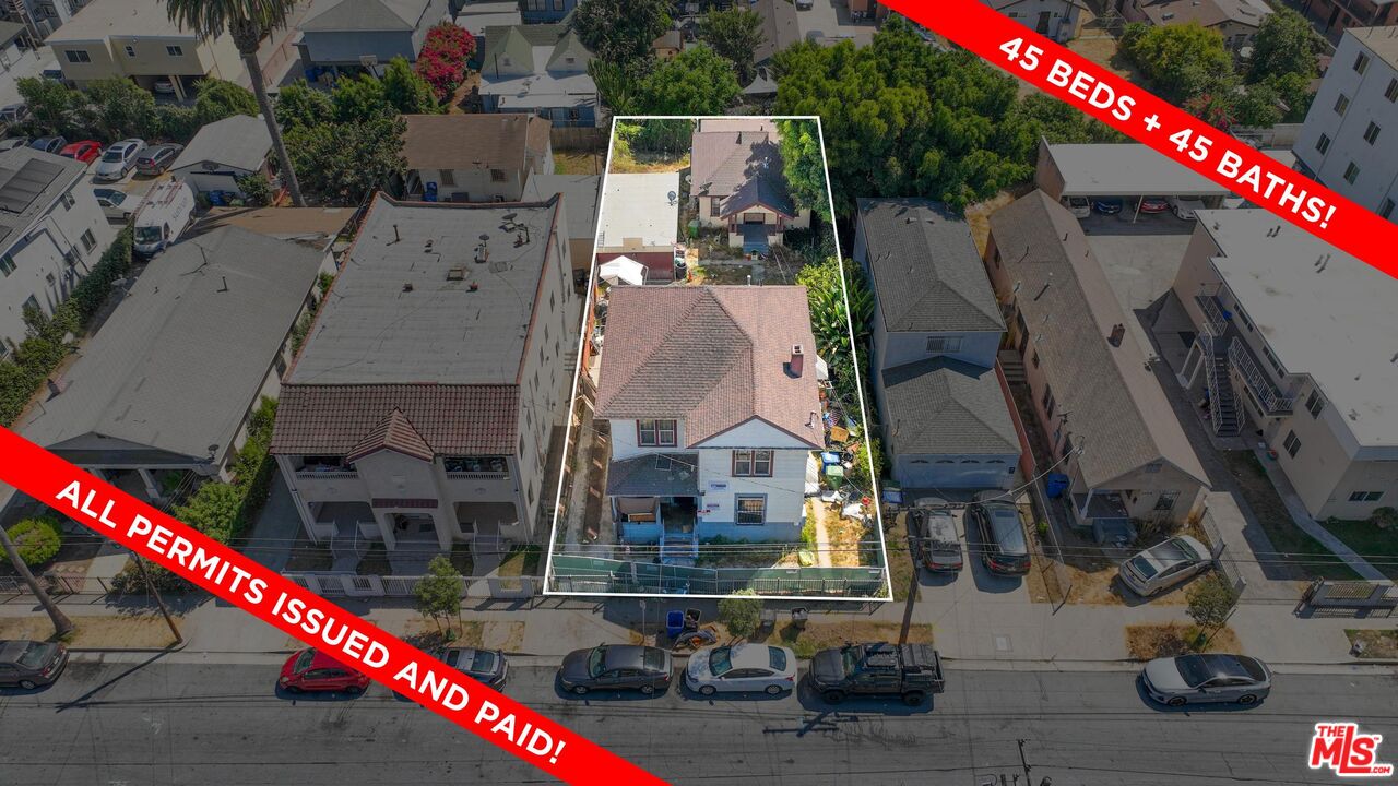 an aerial view of a houses with street