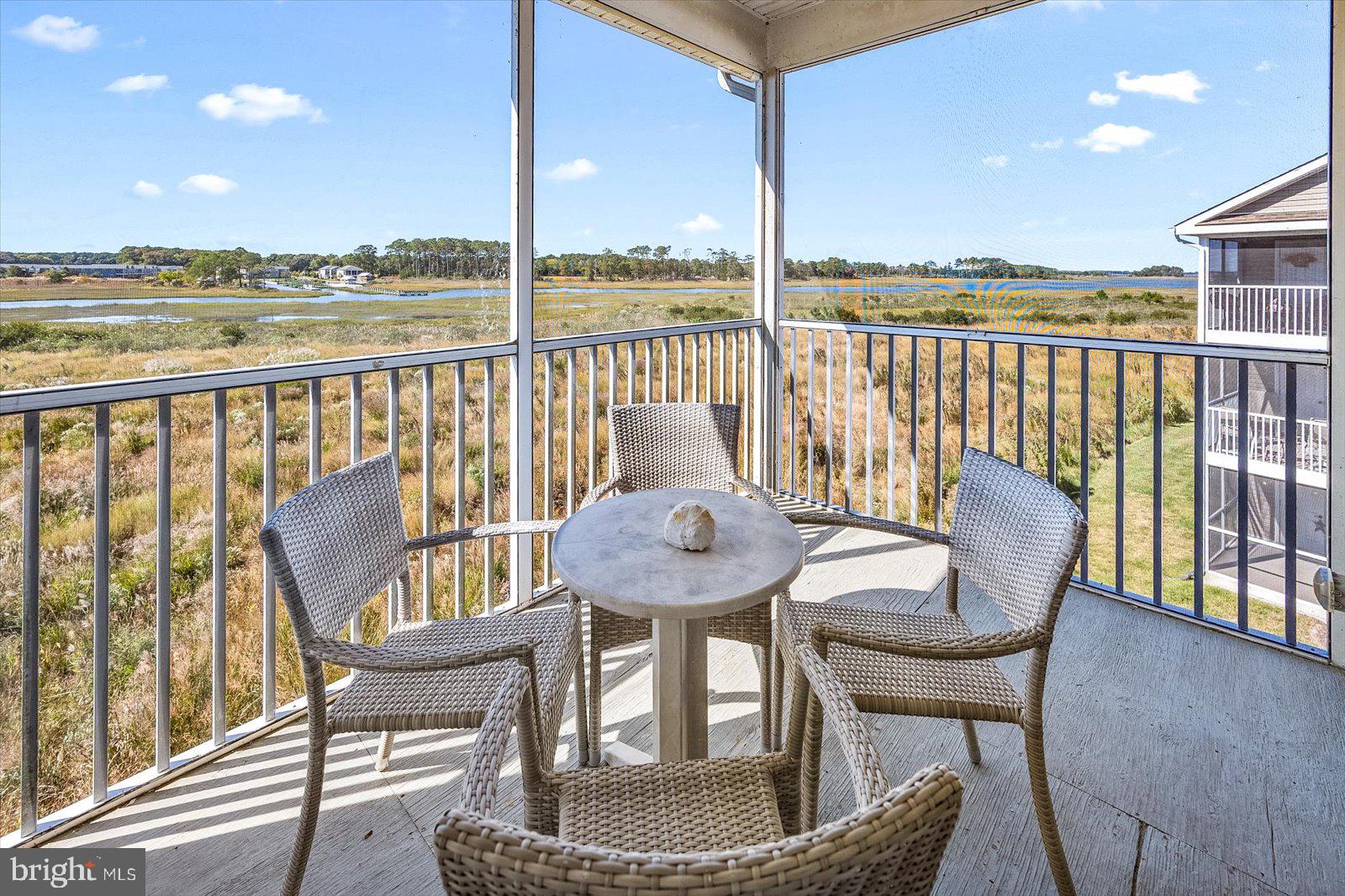 a view of a balcony with chair and wooden floor