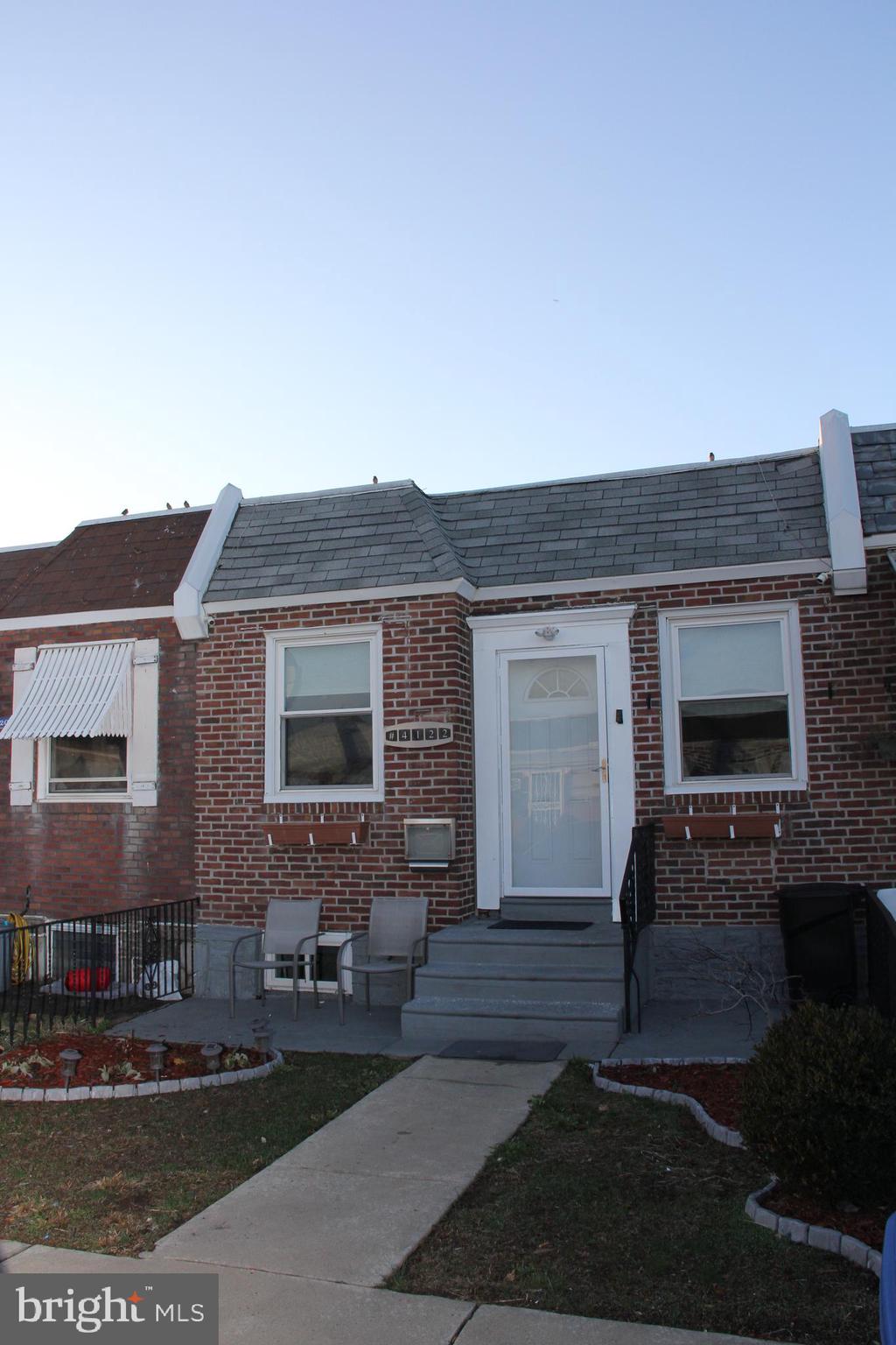 a front view of a house with yard