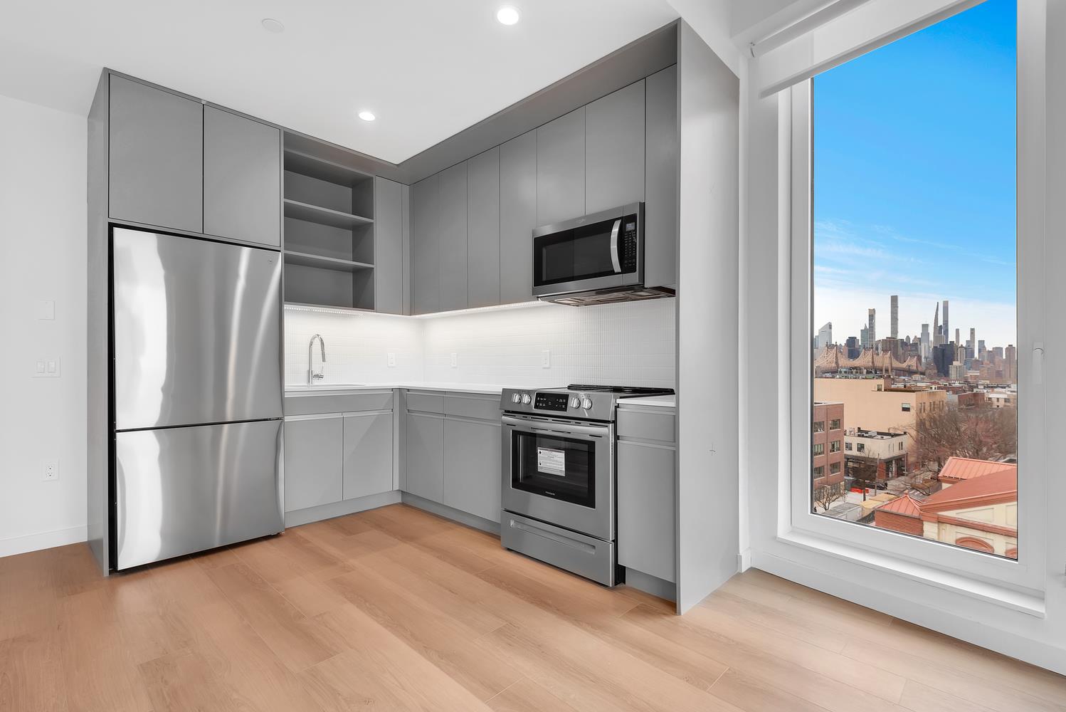 a kitchen with stainless steel appliances a refrigerator sink and microwave