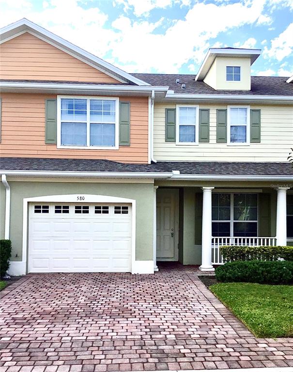 a front view of a house with a yard and a garage