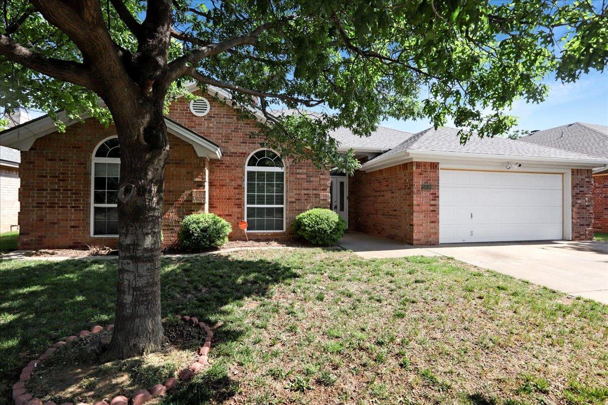 front view of a house with a trees