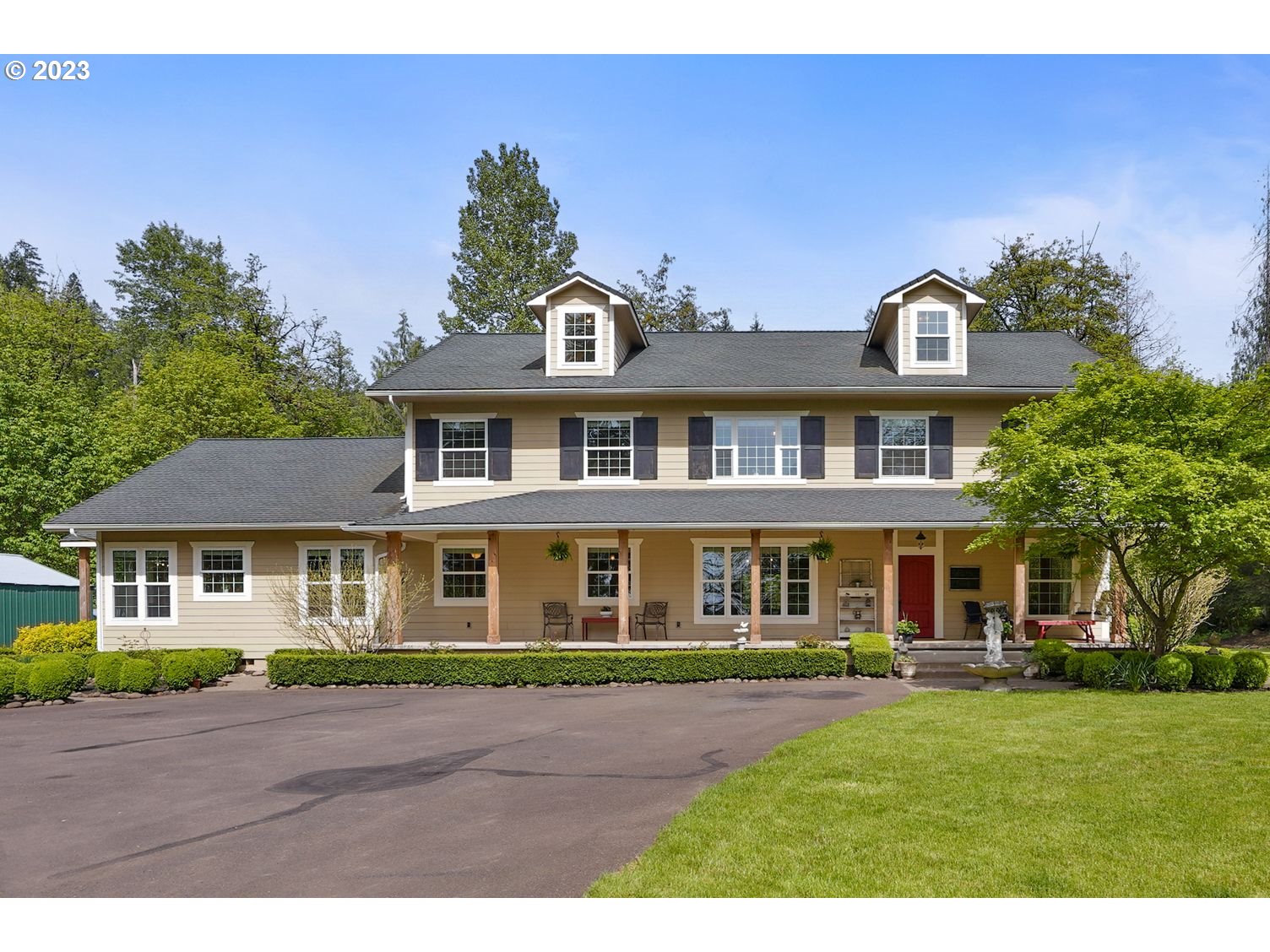 a front view of a house with a garden