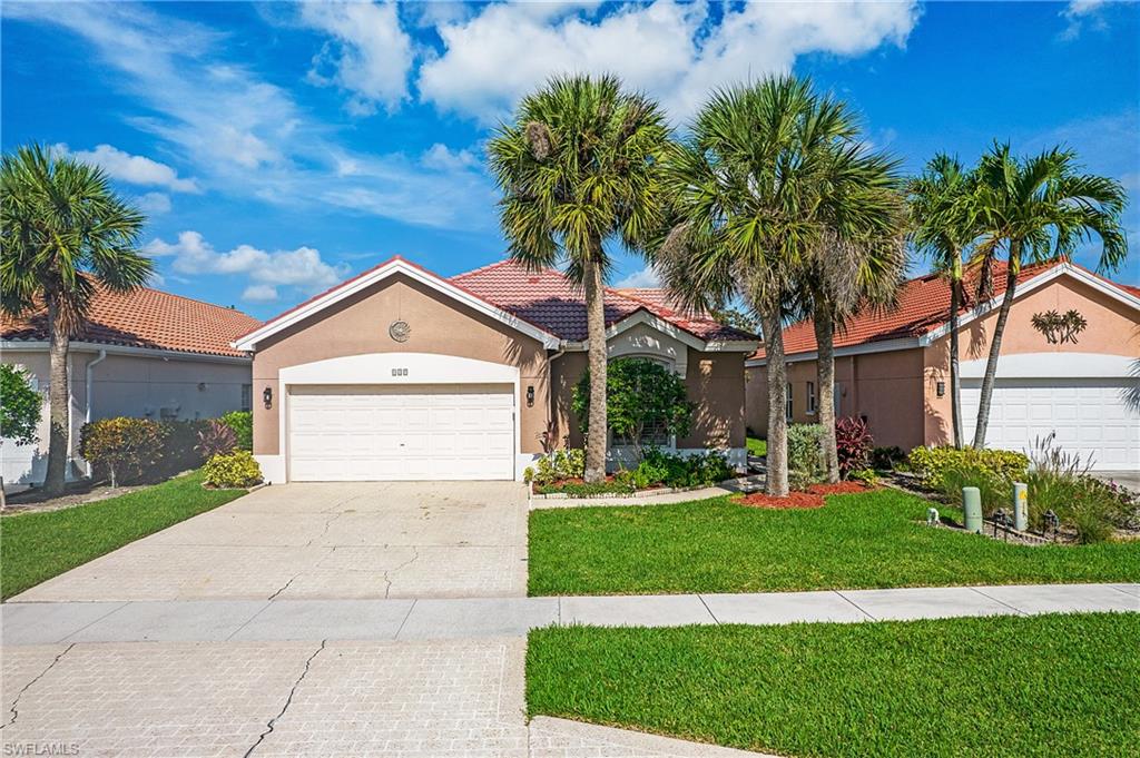 a front view of a house with a yard and garage